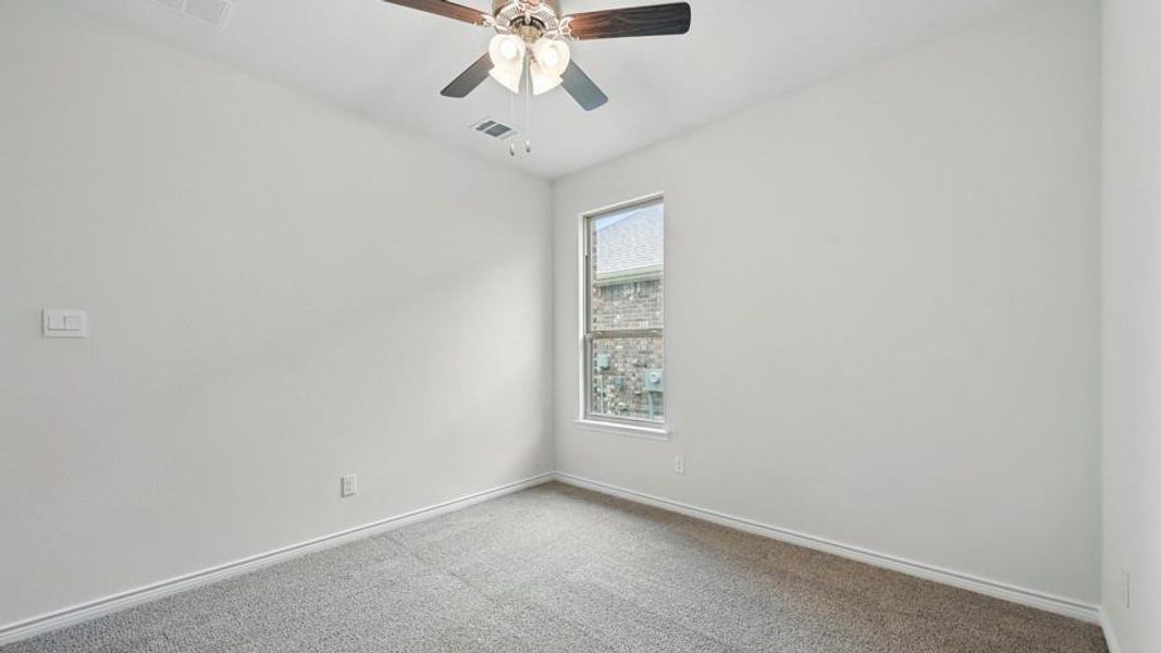 Neutral-toned carpet flooring and light gray painted walls with white trim