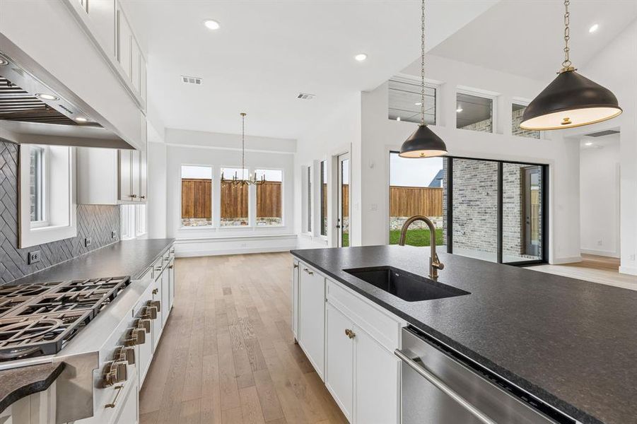 Gorgeous cabinetry, beautiful counter tops and designer backsplash pair effortlessly with contemporary stainless steel to create a kitchen for the ages!