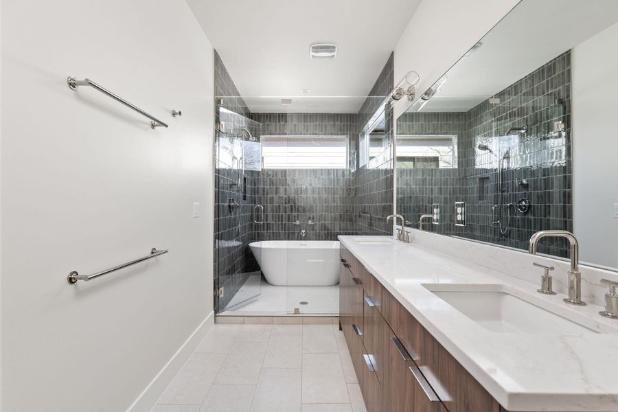 Full bathroom with a sink, a soaking tub, double vanity, and tile patterned flooring