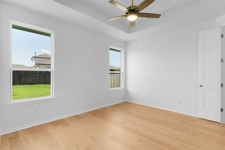 Spare room with light wood-type flooring and a ceiling fan Spare room with light wood-type flooring and a ceiling fan