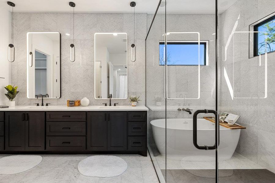 The ensuite bath serves is your daily home spa getaway with a large frameless glass shower surrounded in designer tile and a freestanding soaking tub.