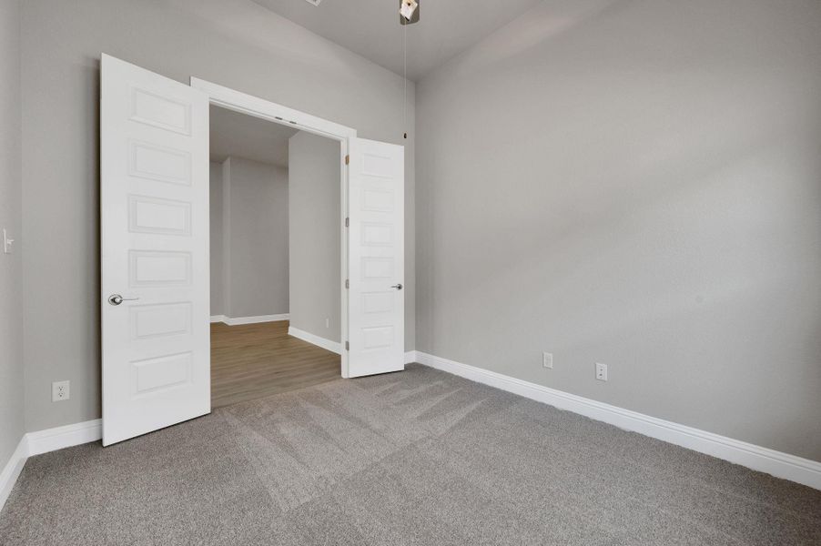 Unfurnished bedroom featuring carpet floors and baseboards