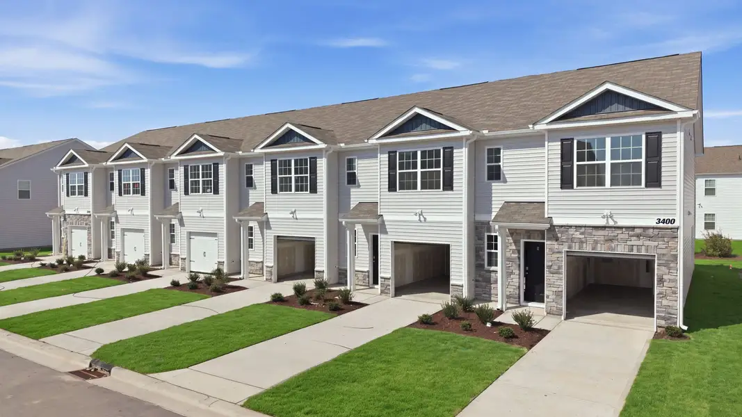 Front exterior of a new home in The Townes at Ridgewood Farms, Winterville, NC, highlighting curb appeal (Image 23).