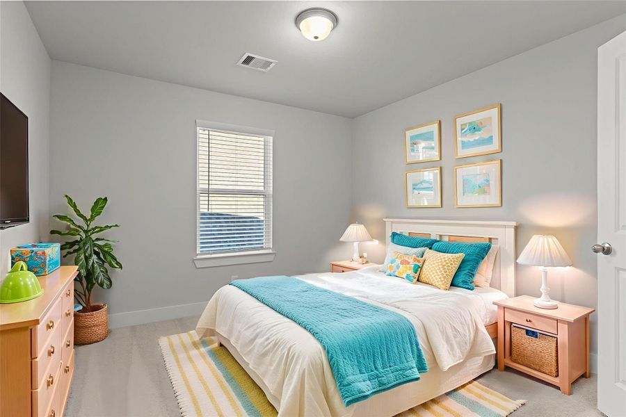 Virtually staged — Another secondary bedroom is bright and cheerful, offering cozy comfort and flexible space that’s perfect for guests, children, or a home office setup.