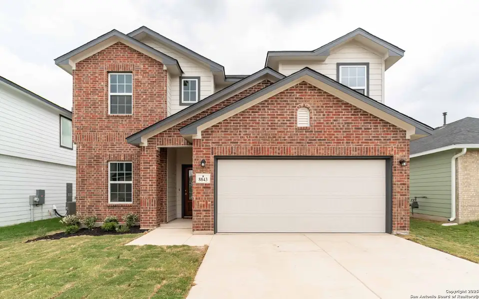 Front exterior of a new home in Hickory Ridge, Elmendorf, TX, highlighting curb appeal (Image 1). Front exterior of a new home in Hickory Ridge, Elmendorf, TX, highlighting curb appeal (Image 1).