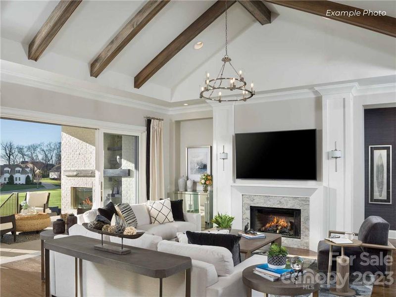 Sleek Fireplace and Massive Sliding Glass Doors from the Great Room to Covered Porch