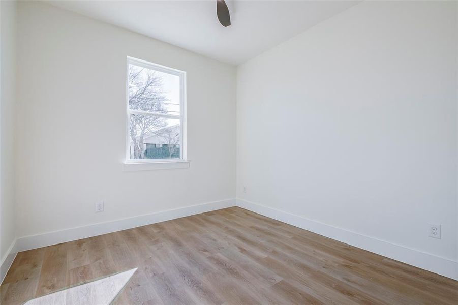 Spare room with ceiling fan and light hardwood / wood-style floors