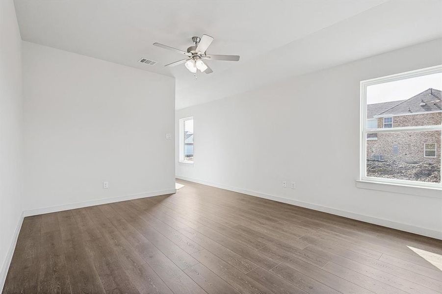 Empty room featuring ceiling fan and wood-type flooring