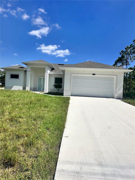 Front exterior of a new home in , Lehigh Acres, FL, highlighting curb appeal (Image 1). Front exterior of a new home in , Lehigh Acres, FL, highlighting curb appeal (Image 1).