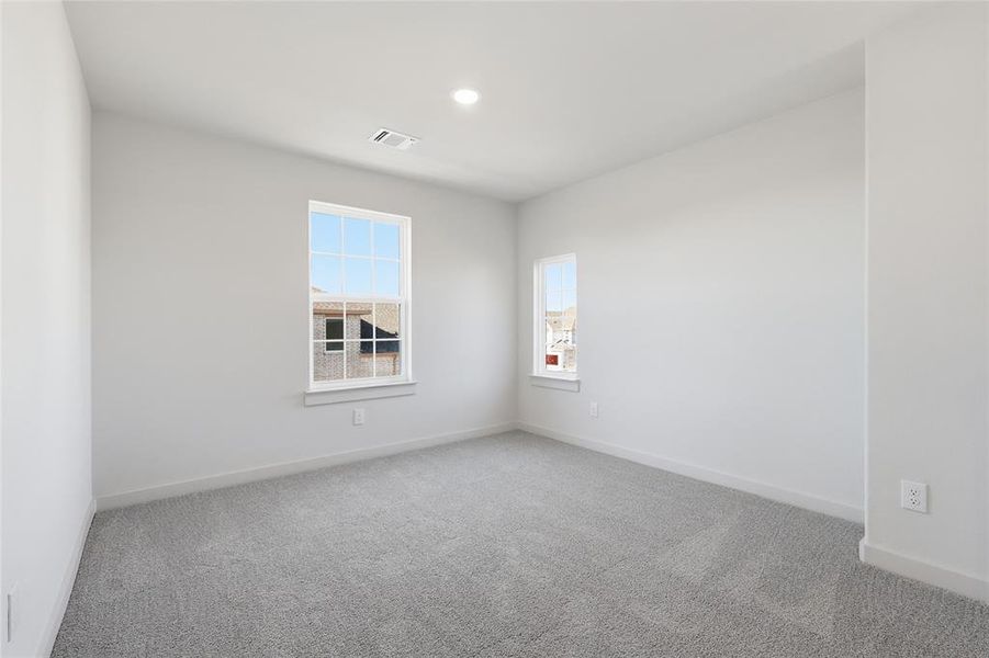 Light gray carpeting in an interior room with white walls and trim