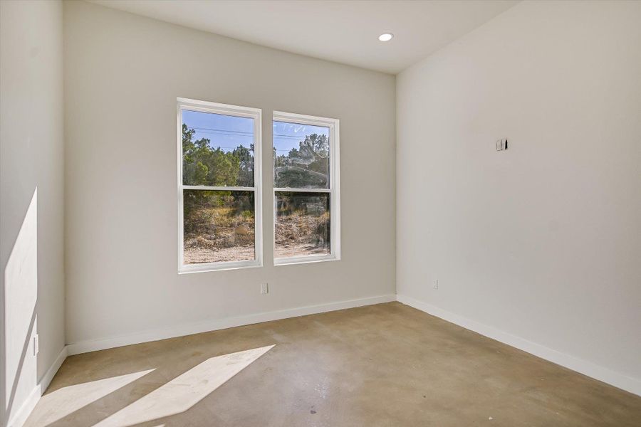 Unfurnished room featuring concrete flooring and recessed lighting