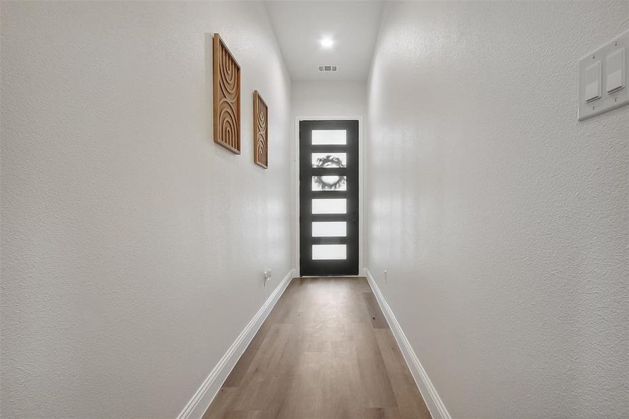 Doorway featuring wood-type flooring and a wealth of natural light