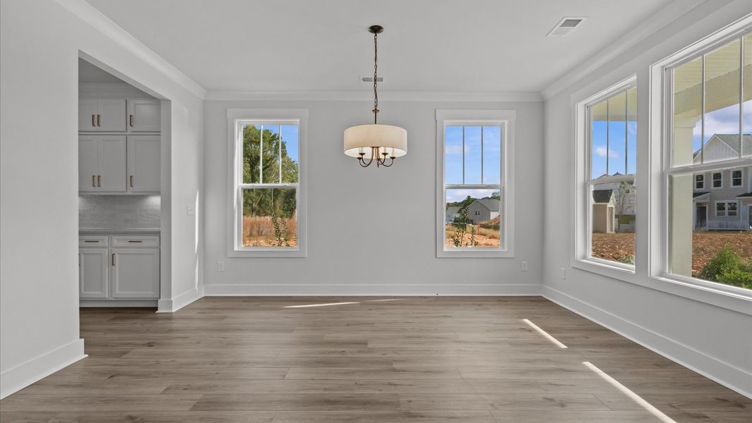Elegant dining room opens to a functional floor plan with tasteful upgrades throughout