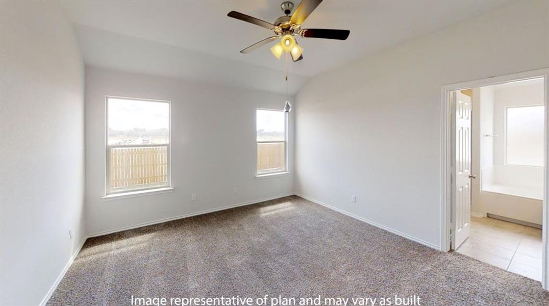 Spacious bedroom with vaulted ceiling, two windows, ceiling fan with light fixture, and carpeted flooring Spacious bedroom with vaulted ceiling, two windows, ceiling fan with light fixture, and carpeted flooring