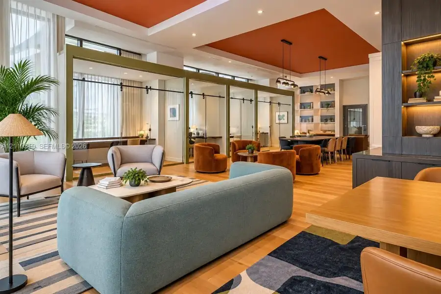 Open-concept common area featuring wood-finish flooring, recessed tray ceilings with accent color, floor-to-ceiling glass-paneled partition walls with sliding hardware, and custom built-in floor-to-ceiling shelving with integrated lighting Open-concept common area featuring wood-finish flooring, recessed tray ceilings with accent color, floor-to-ceiling glass-paneled partition walls with sliding hardware, and custom built-in floor-to-ceiling shelving with integrated lighting