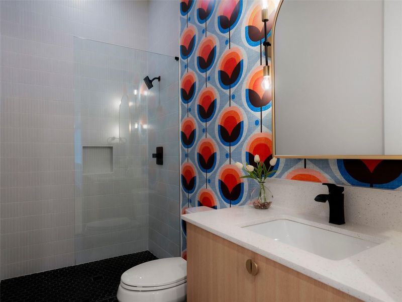 Secondary Bath with wallpaper that stays true to the MCM feel of the home.