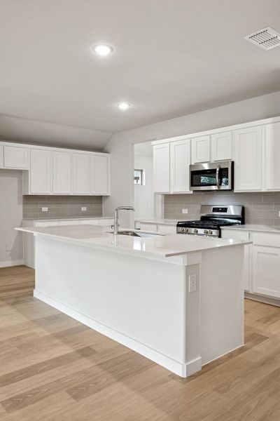 Kitchen in the Heisman home plan by Trophy Signature Homes – REPRESENTATIVE PHOTO