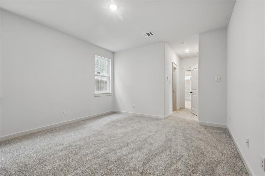 Unfurnished room with attic access, recessed lighting, baseboards, visible vents, and light carpet Unfurnished room with attic access, recessed lighting, baseboards, visible vents, and light carpet