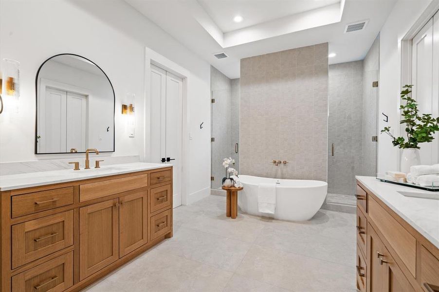 Primary bathroom with custom his and her's vanities. Previous TOMO Homes project.