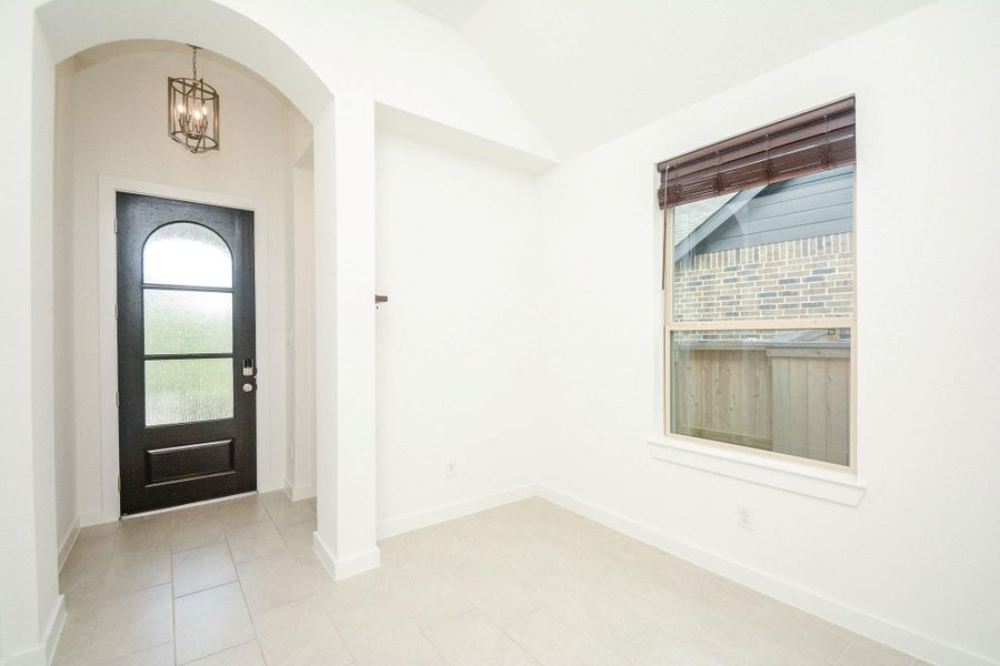 Bright and welcoming entryway with soaring ceilings and elegant archways. Bright and welcoming entryway with soaring ceilings and elegant archways.