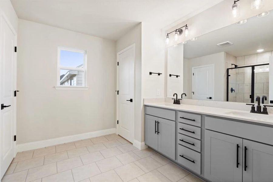 Bathroom featuring vanity and an enclosed shower