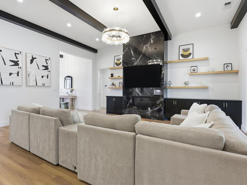 Living area featuring a black marble-style fireplace surround with a linear electric fireplace