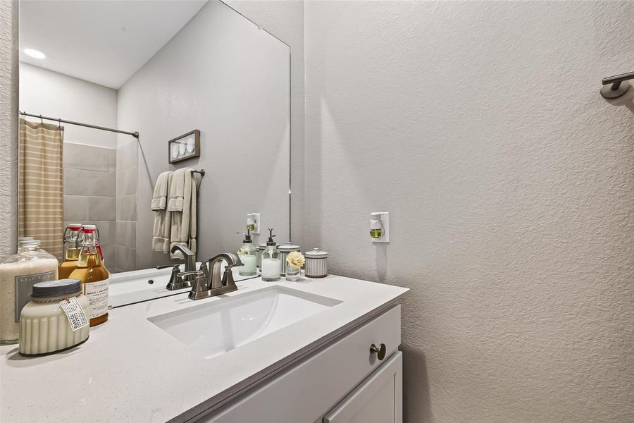 Secondary bath with vanity and generous counter space. Secondary bath with vanity and generous counter space.