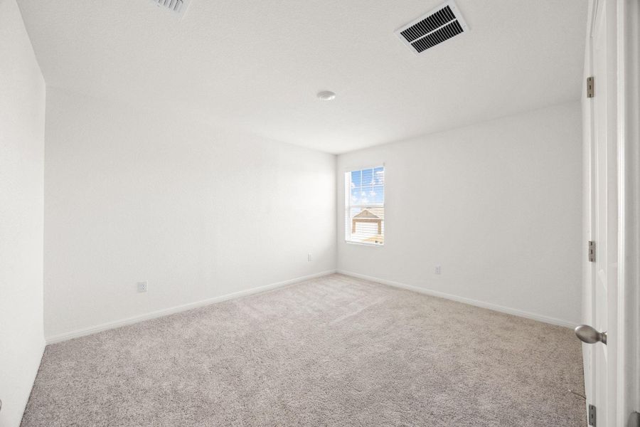 Empty room featuring carpet and baseboards