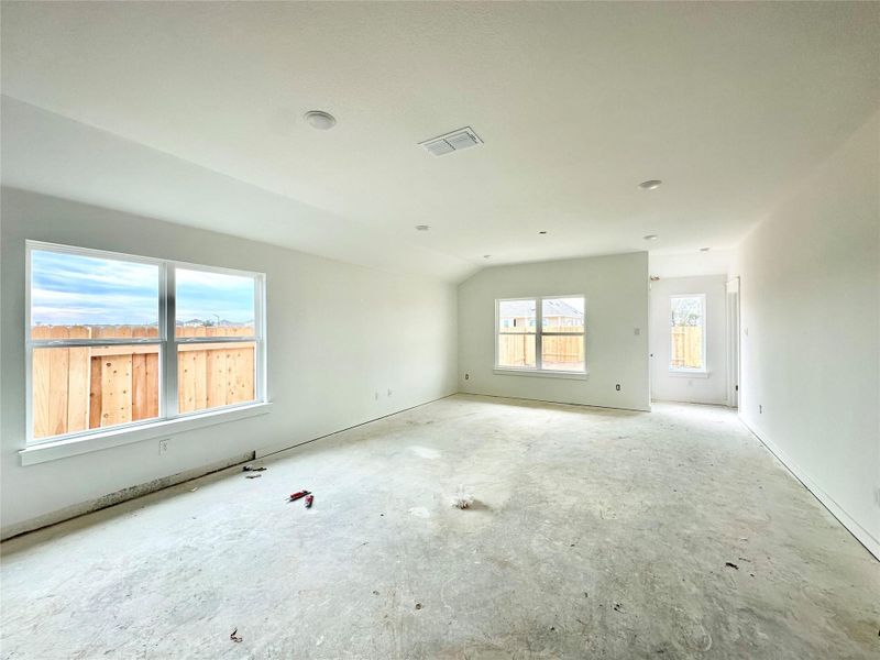 Unfurnished room with lofted ceiling