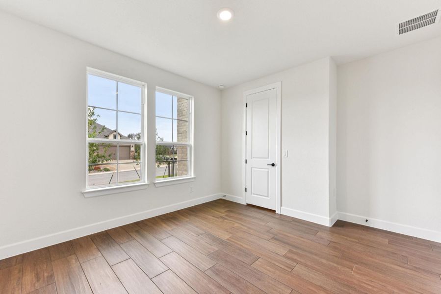 Unfurnished room featuring wood finished floors and recessed lighting