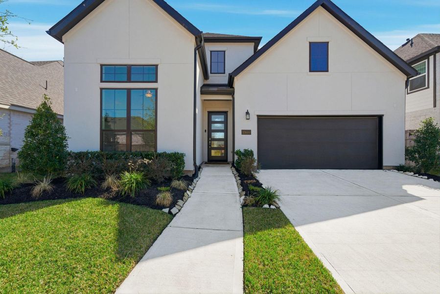 Front exterior of a new home in Sienna, Missouri City, TX, highlighting curb appeal (Image 23).