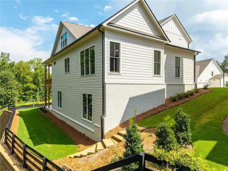 Exterior details and patio area of a home in Malone's Pond, Ball Ground (Image 24).