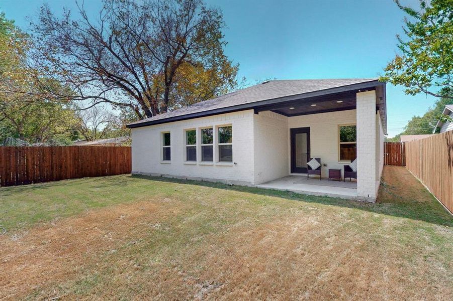 Back of house featuring a patio and a lawn