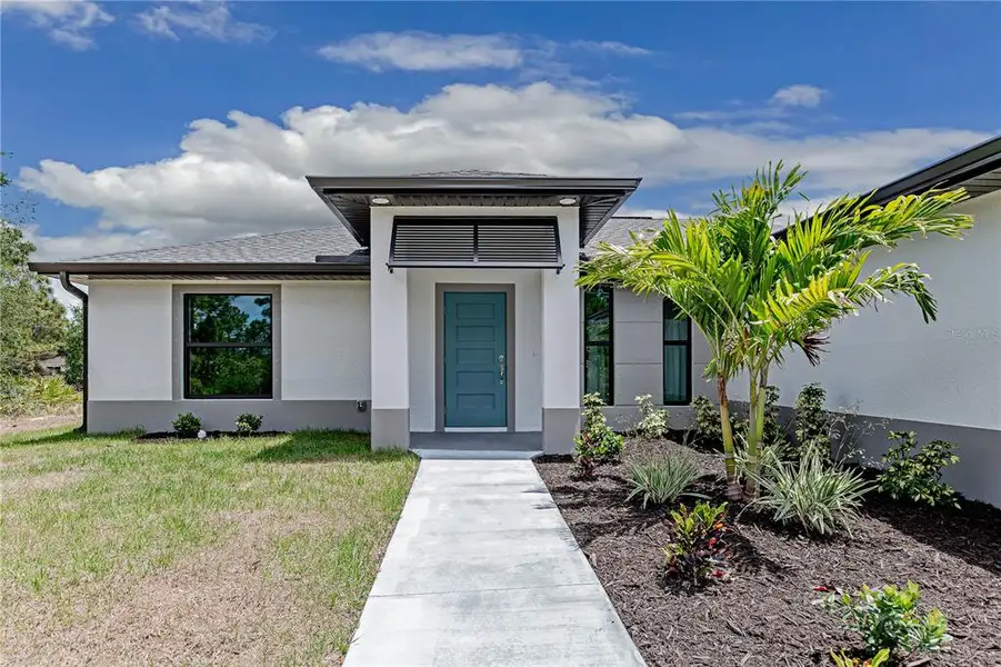 Front exterior of a new home in , Punta Gorda, FL, highlighting curb appeal (Image 2). Front exterior of a new home in , Punta Gorda, FL, highlighting curb appeal (Image 2).