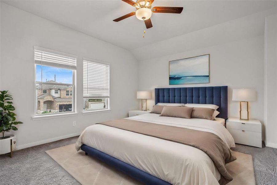 Retreat to your tranquil primary suite, featuring plush carpeting and large windows that fill the room with natural light. This serene space is designed for relaxation, with ample room for a king-sized bed and additional furniture. The en-suite bathroom and walk-in closet add a touch of luxury to your everyday life. **This image is from another Saratoga Home with similar floor plan and finishes, not the Brayden floorplan.**