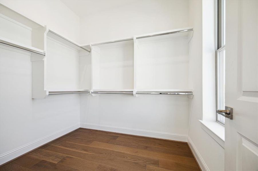 Second primary closet with built-in window for natural light.