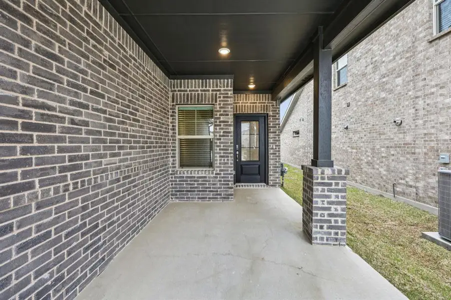 Exterior details and patio area of a home in Parks at Foster Crossing - Spring Series, Anna (Image 3).