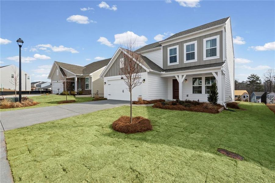 Front exterior of a new home in Twin Lakes, Hoschton, GA, highlighting curb appeal (Image 20). Front exterior of a new home in Twin Lakes, Hoschton, GA, highlighting curb appeal (Image 20).