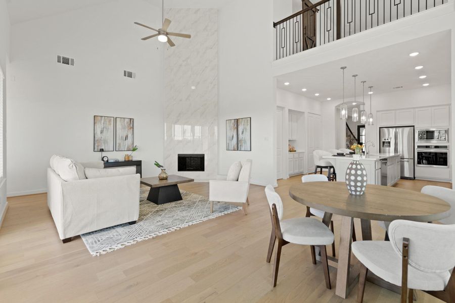Warm and inviting, this stunning living space features a floor to ceiling tile fireplace- a huge upgrade and top notch design feature, creating the perfect ambiance for relaxation. The natural light floods the room, while the open layout seamlessly connects to the kitchen and dining room.