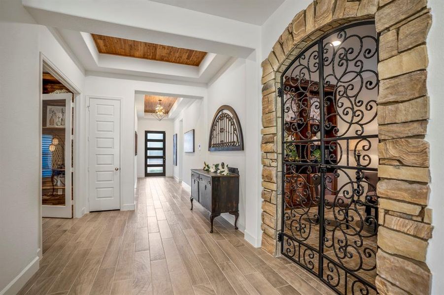 The wine grotto gives a taste of Italy it's with rustic stone arch framing a decorative wrought iron gate with intricate scrollwork, adding character and charm.