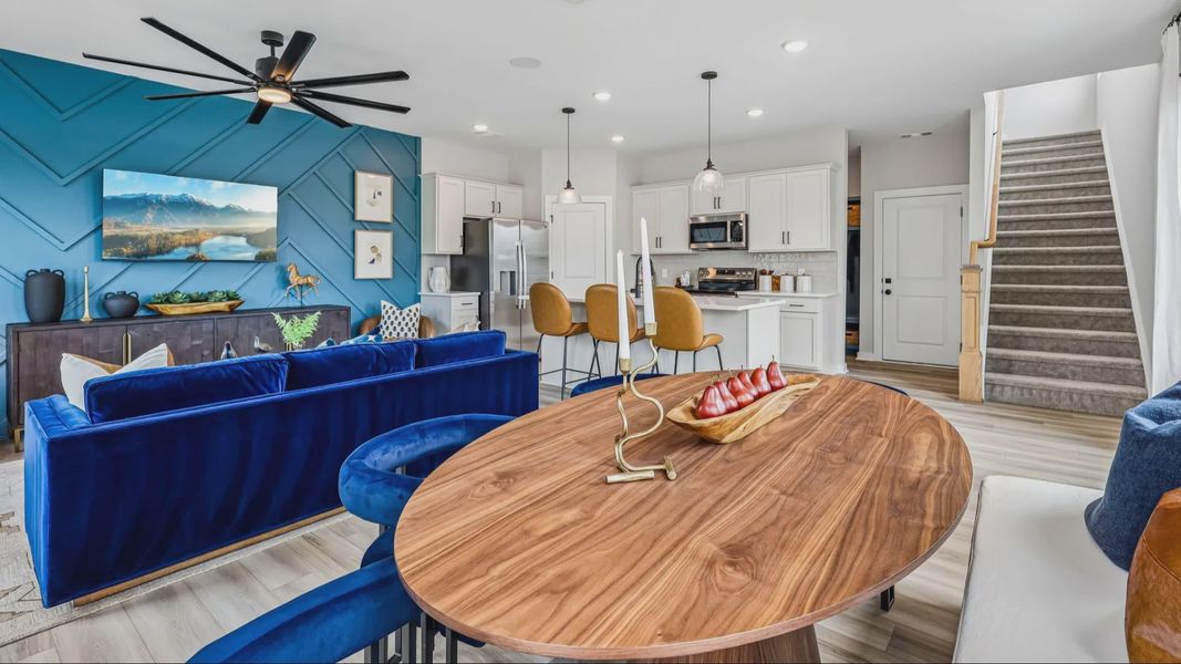 First floor view of gathering room, dining area, and kitchen