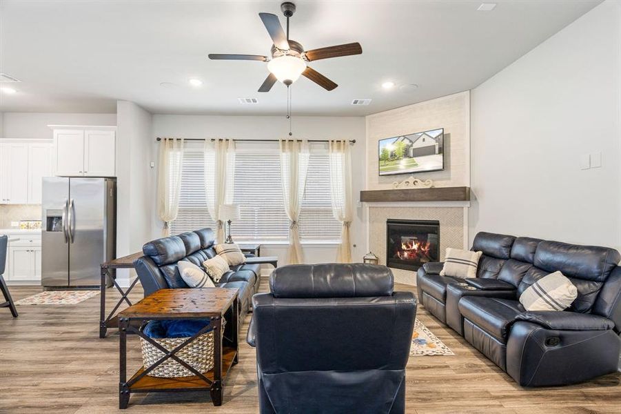 Living area with wood-finish flooring, recessed lighting, and a ceiling fan Living area with wood-finish flooring, recessed lighting, and a ceiling fan