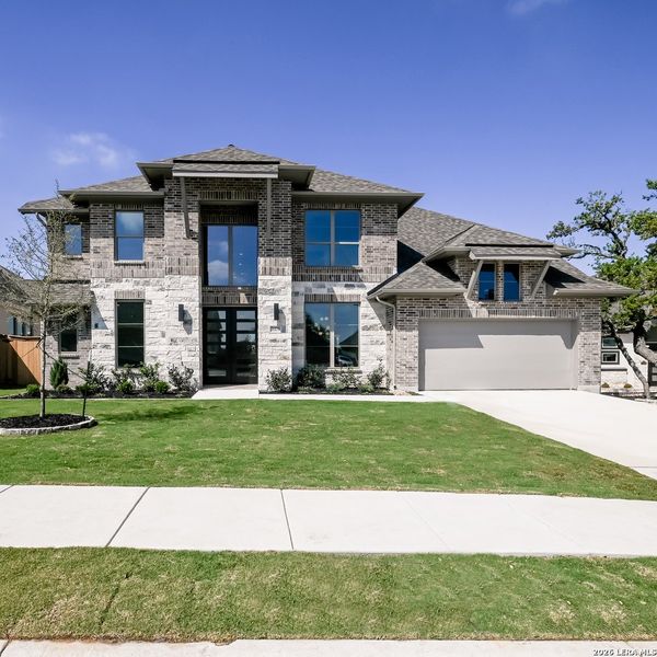 Front exterior of a new home in Johnson Ranch, Bulverde, TX, highlighting curb appeal (Image 21). Front exterior of a new home in Johnson Ranch, Bulverde, TX, highlighting curb appeal (Image 21).