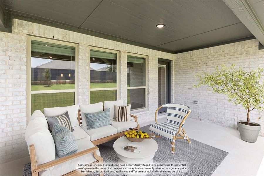 Covered back patio with white brick walls, outdoor seating, and view of backyard Covered back patio with white brick walls, outdoor seating, and view of backyard