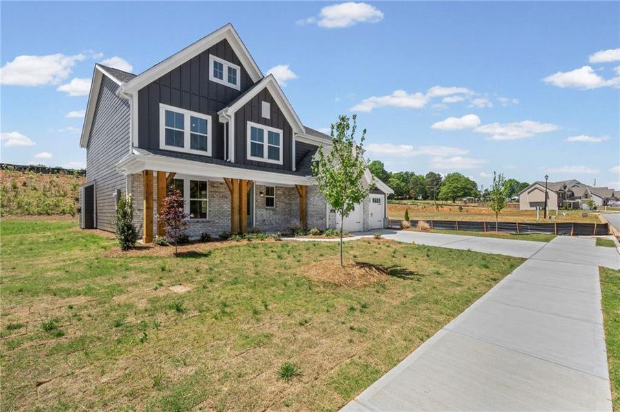 Front exterior of a new home in Hidden Fields, Hoschton, GA, highlighting curb appeal (Image 27). Front exterior of a new home in Hidden Fields, Hoschton, GA, highlighting curb appeal (Image 27).
