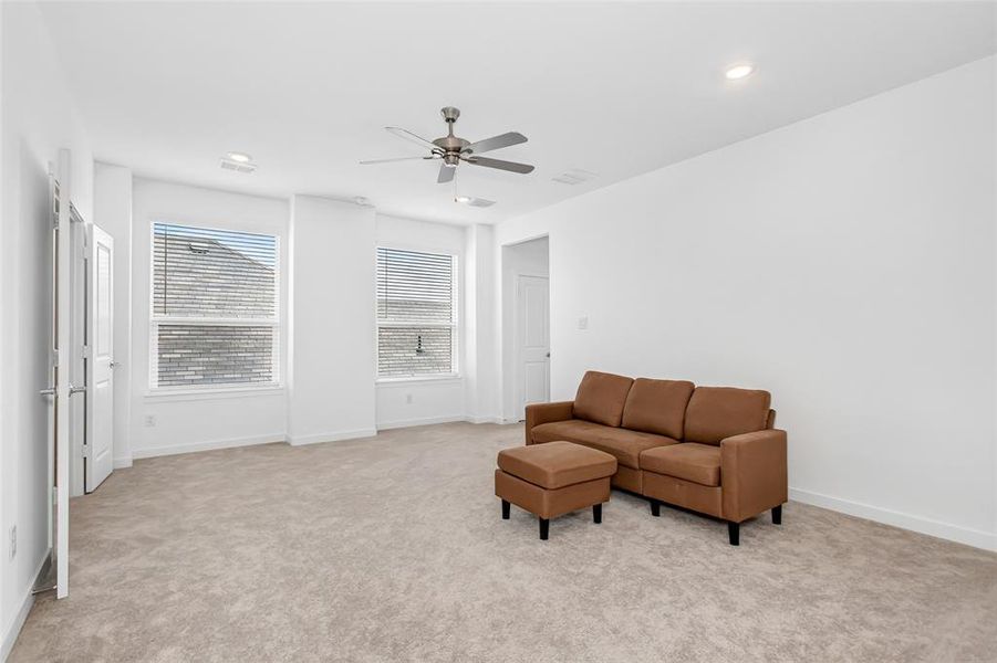 Spacious room with light-toned carpeting and white walls