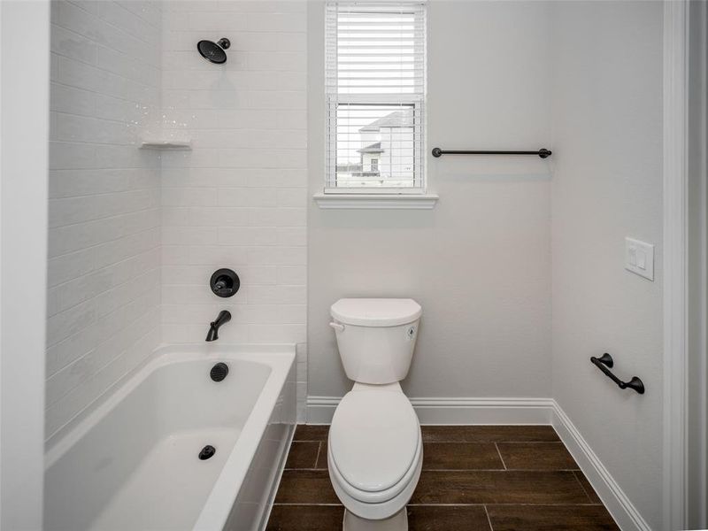 Full bathroom featuring shower / bath combination and wood finish floors
