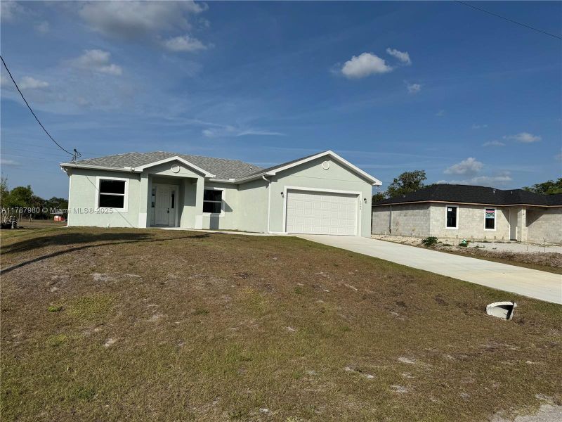 Front exterior of a new home in , Labelle, FL, highlighting curb appeal (Image 11).