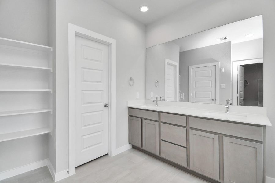 Elevate your daily routine at the elegant vanity, now equipped with double sinks, light countertops, modern hardware, and beautiful recessed lights. Sample photo of completed home with similar floor plan. Actual colors and selections may vary. Elevate your daily routine at the elegant vanity, now equipped with double sinks, light countertops, modern hardware, and beautiful recessed lights. Sample photo of completed home with similar floor plan. Actual colors and selections may vary.