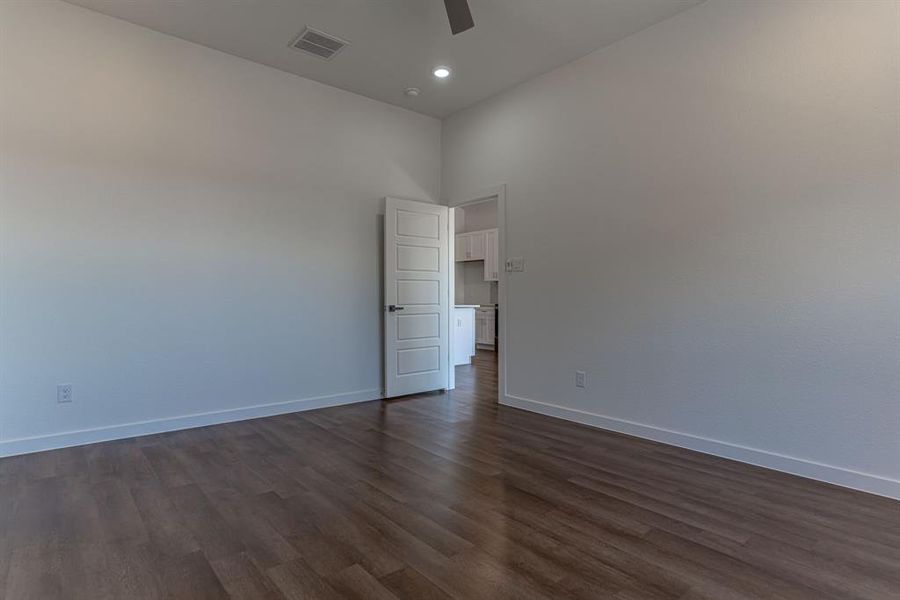 Primary bedroom with luxury vinyl flooring throughout